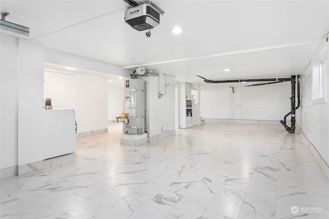 garage with washer / dryer, strapped water heater, and a garage door opener