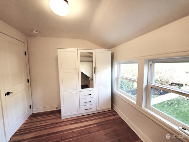 unfurnished bedroom featuring dark hardwood / wood-style floors and vaulted ceiling