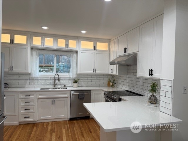 kitchen featuring white cabinetry, sink, stainless steel appliances, and light hardwood / wood-style floors