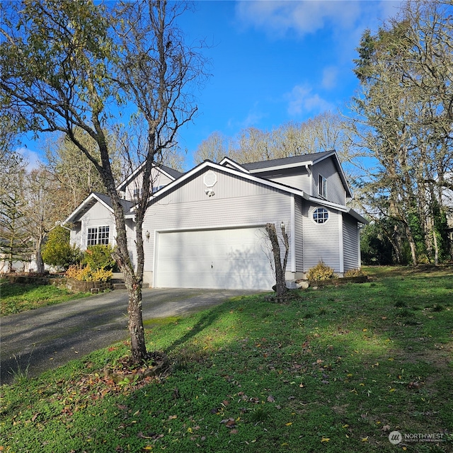 view of front of home with a garage and a front yard