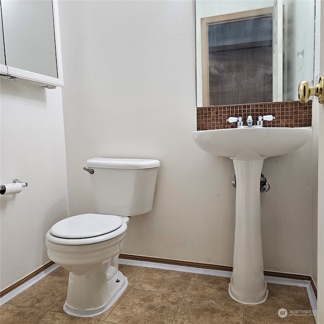 bathroom with tile patterned floors, decorative backsplash, and toilet