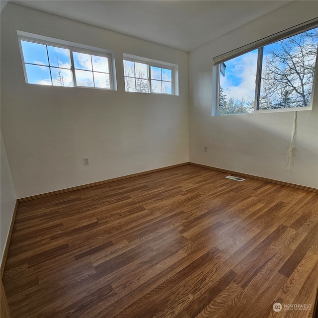 unfurnished room with dark hardwood / wood-style floors