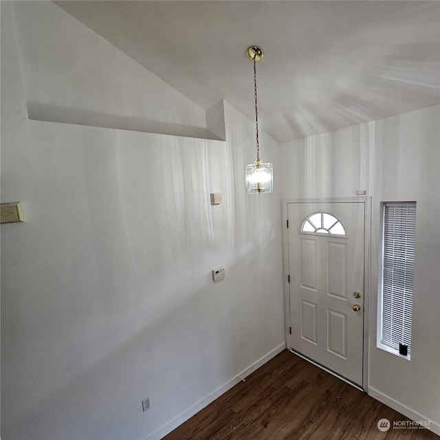 foyer entrance with vaulted ceiling and dark wood-type flooring