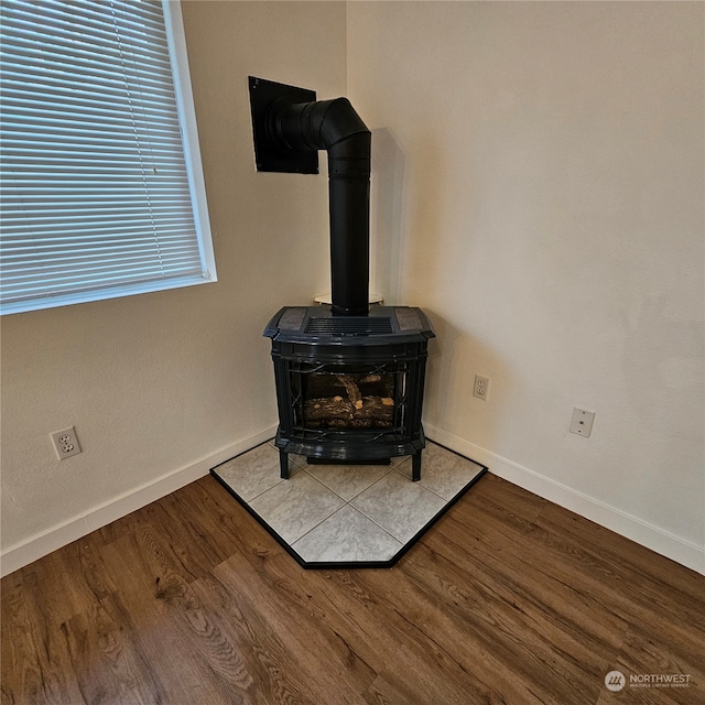 details featuring wood-type flooring and a wood stove