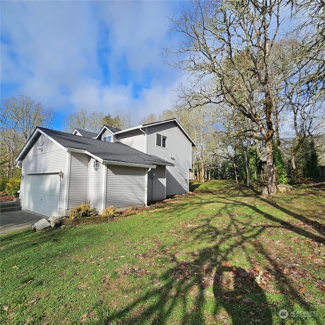 view of property exterior featuring a yard and a garage