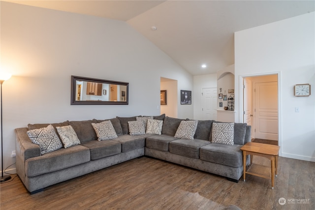 living room featuring dark hardwood / wood-style flooring and high vaulted ceiling