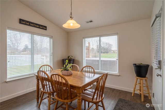 dining area featuring dark hardwood / wood-style flooring and lofted ceiling