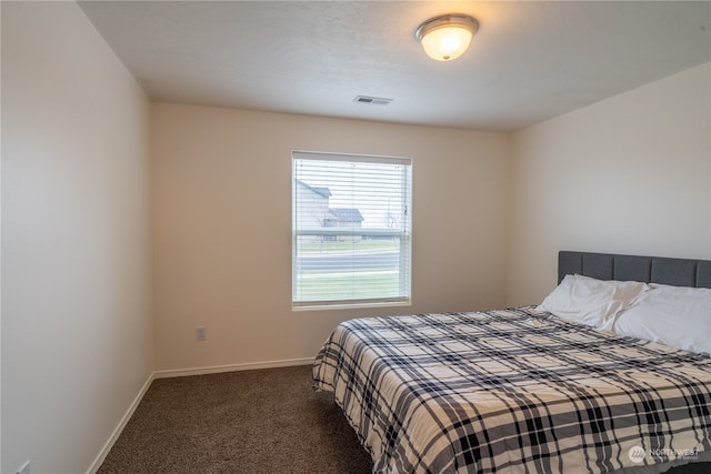 bedroom featuring dark colored carpet