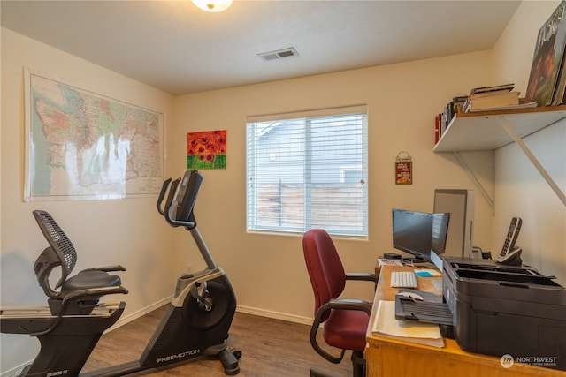 home office with hardwood / wood-style flooring