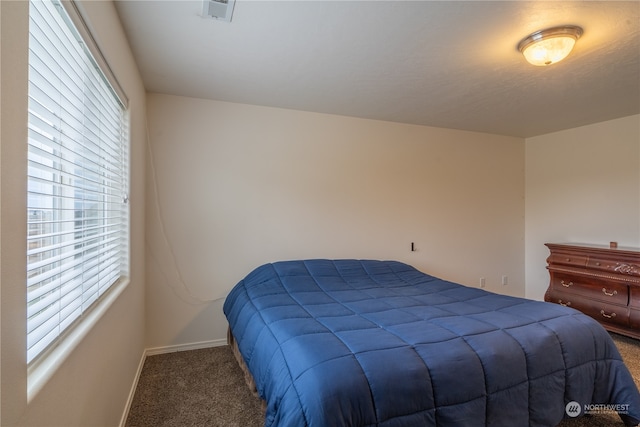 bedroom with dark carpet