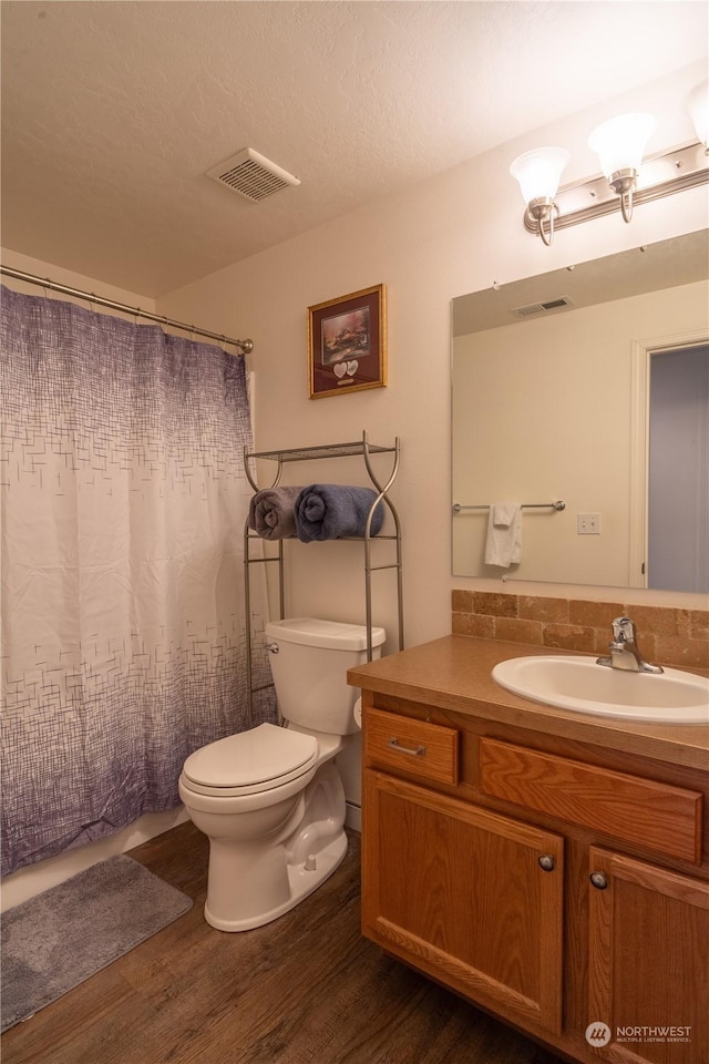 805 S Hamilton Rd, Moses Lake, WA 98837 - full bathroom featuring toilet, vanity, wood finished floors, and curtained shower