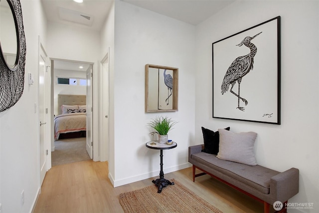 hallway with light wood-style floors and baseboards