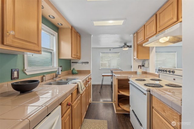 kitchen featuring ceiling fan, tile counters, sink, dark wood-type flooring, and electric stove