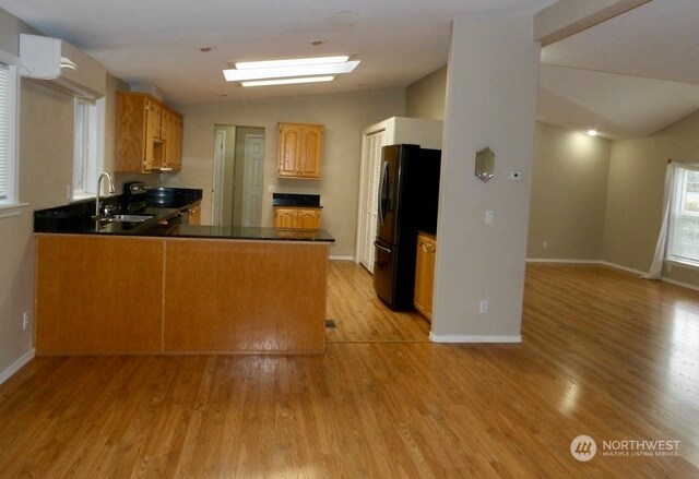 2722 S 371st St, Federal Way, WA 98003 - kitchen with sink, kitchen peninsula, light hardwood / wood-style flooring, and vaulted ceiling