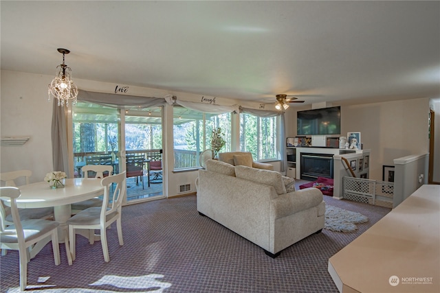 living room featuring ceiling fan and dark colored carpet