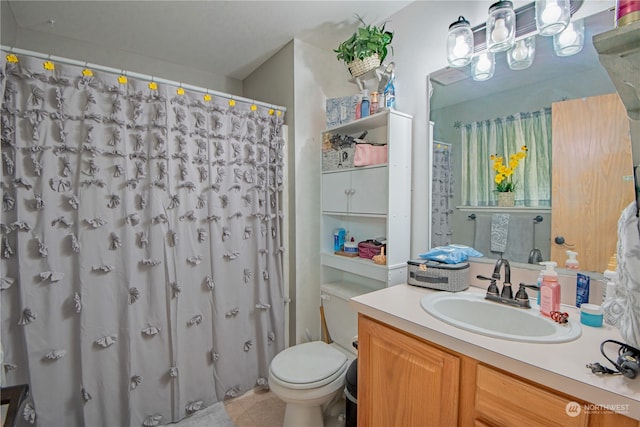 bathroom with vanity, toilet, and curtained shower