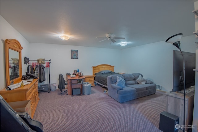 bedroom featuring ceiling fan and dark carpet