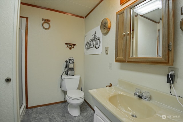 bathroom with vanity, walk in shower, crown molding, and toilet