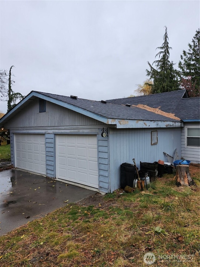 view of side of home featuring a garage