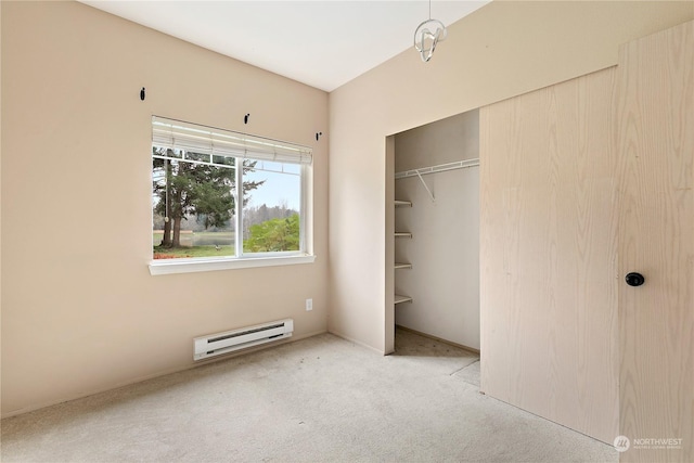 unfurnished bedroom featuring a closet, light colored carpet, and a baseboard heating unit