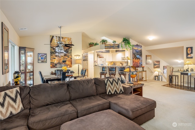 living room featuring carpet and lofted ceiling