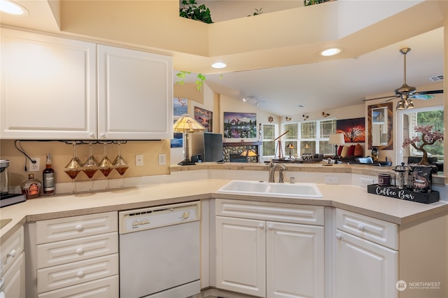 kitchen with kitchen peninsula, dishwasher, and sink