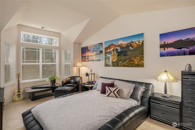 bedroom with lofted ceiling and light carpet