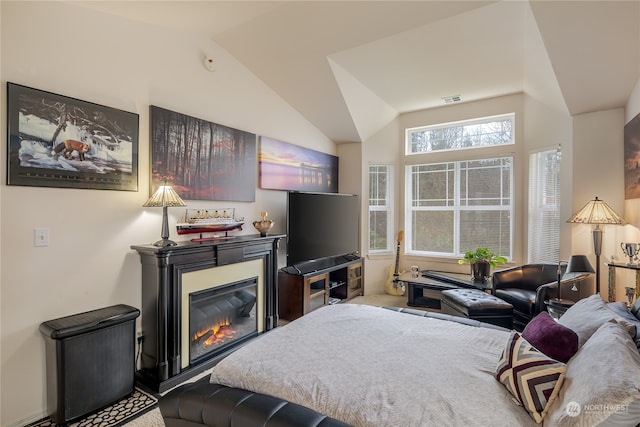 carpeted bedroom with vaulted ceiling