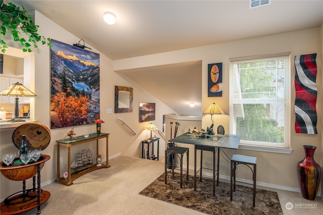 dining space with carpet flooring and lofted ceiling