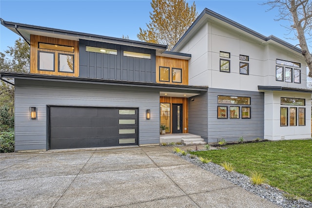 modern home with a garage and a front lawn