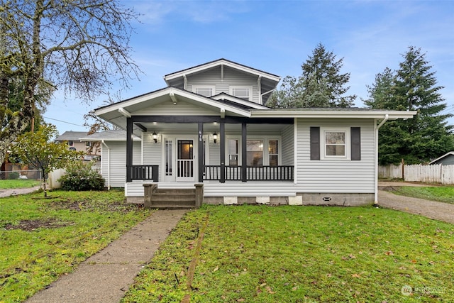 bungalow-style home with a front lawn and covered porch