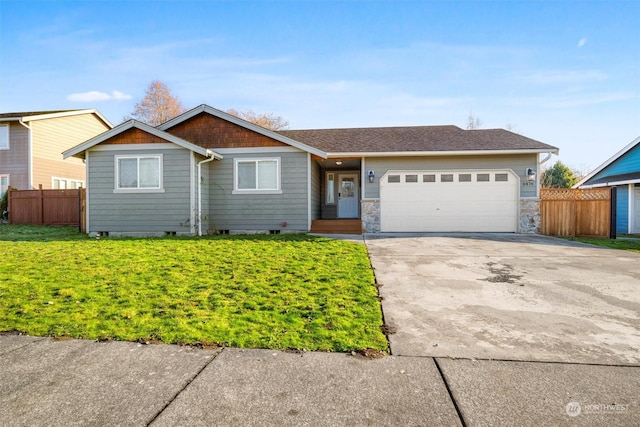 ranch-style home featuring a garage and a front yard