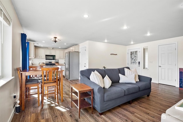 living room featuring wood-type flooring and sink