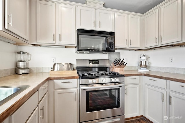 kitchen with white cabinetry, sink, and stainless steel range with gas stovetop