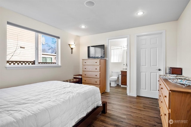 bedroom featuring dark wood-type flooring and ensuite bathroom