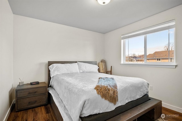 bedroom with dark wood-type flooring