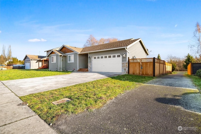 ranch-style house featuring a garage and a front lawn