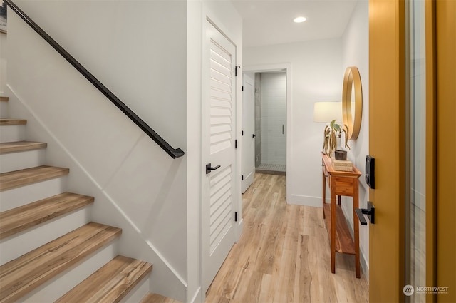 stairway with hardwood / wood-style flooring