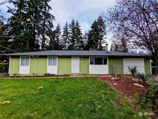 ranch-style house with a garage and a front lawn