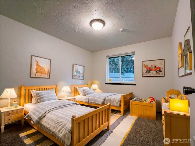 carpeted bedroom with a textured ceiling