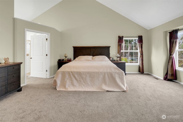 carpeted bedroom with vaulted ceiling