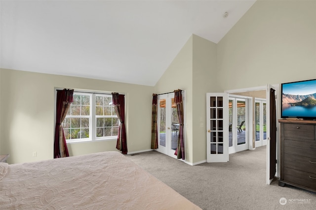 carpeted bedroom with access to exterior, high vaulted ceiling, and french doors