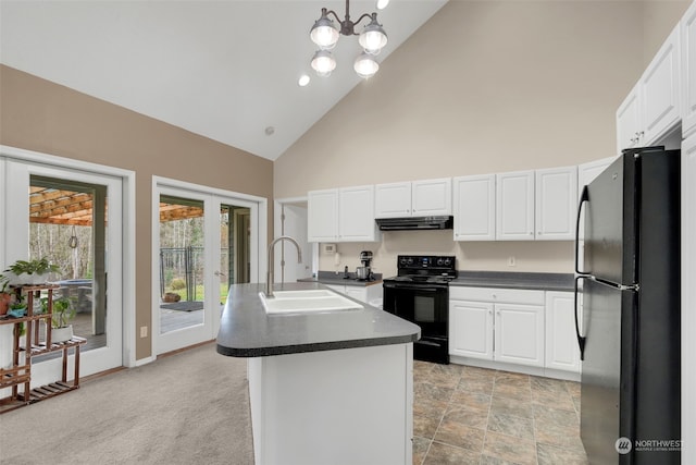 kitchen featuring pendant lighting, high vaulted ceiling, black appliances, sink, and an island with sink