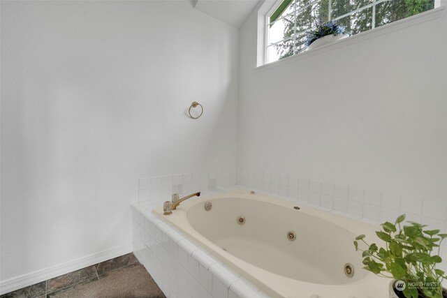 bathroom featuring tiled bath