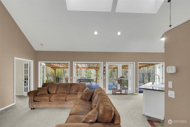 living room with carpet floors, a wealth of natural light, and french doors