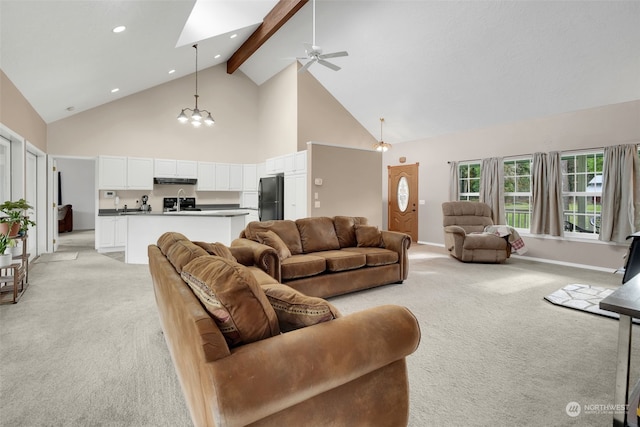 living room with ceiling fan with notable chandelier, beam ceiling, light carpet, and high vaulted ceiling