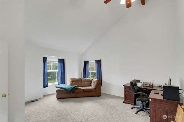 carpeted office with high vaulted ceiling and ceiling fan