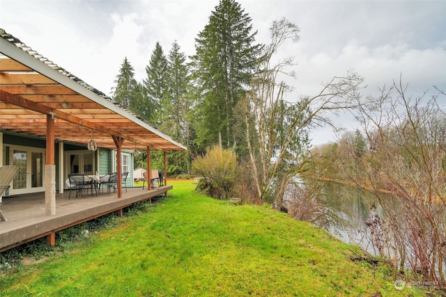 view of yard with french doors and a wooden deck