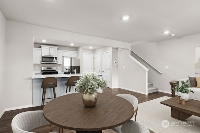 dining area with dark wood-type flooring