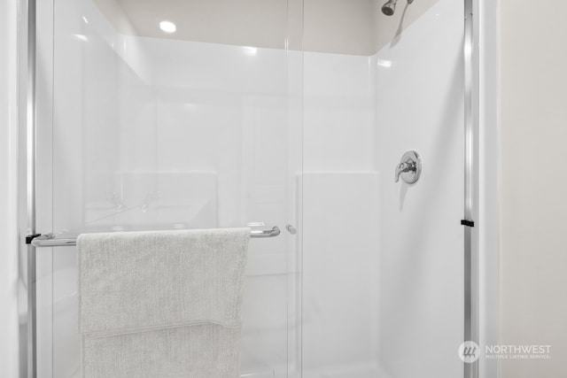 bathroom with a shower with shower door